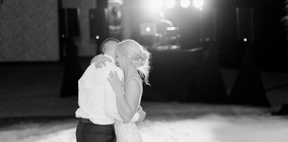 Bride and groom laughing during their first dance