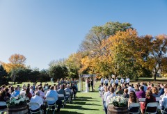 Guests watch the bride and groom get married outdoors