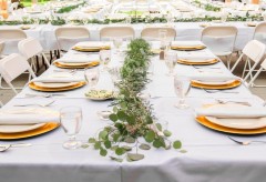 Reception table setup with rectangular tables and place settings